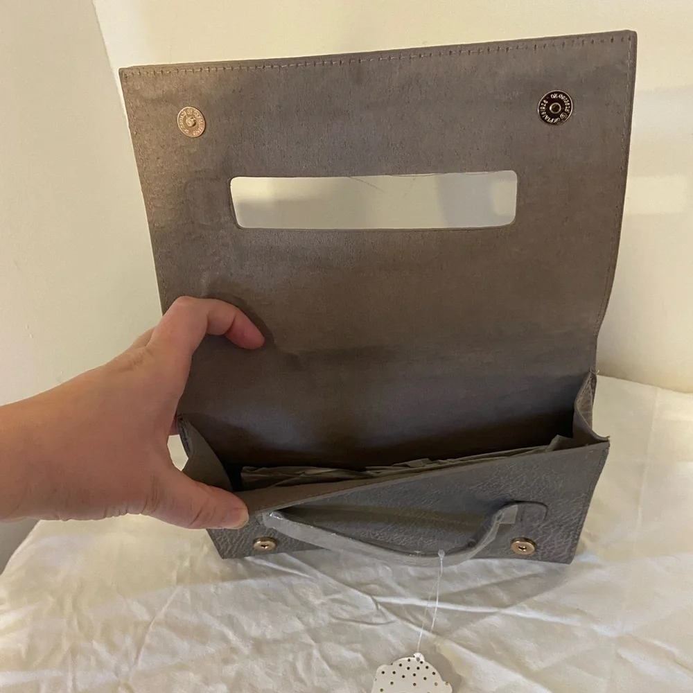 Occasionally made clutch Metallic Leather hand clutch. 9” wide 6” tall new